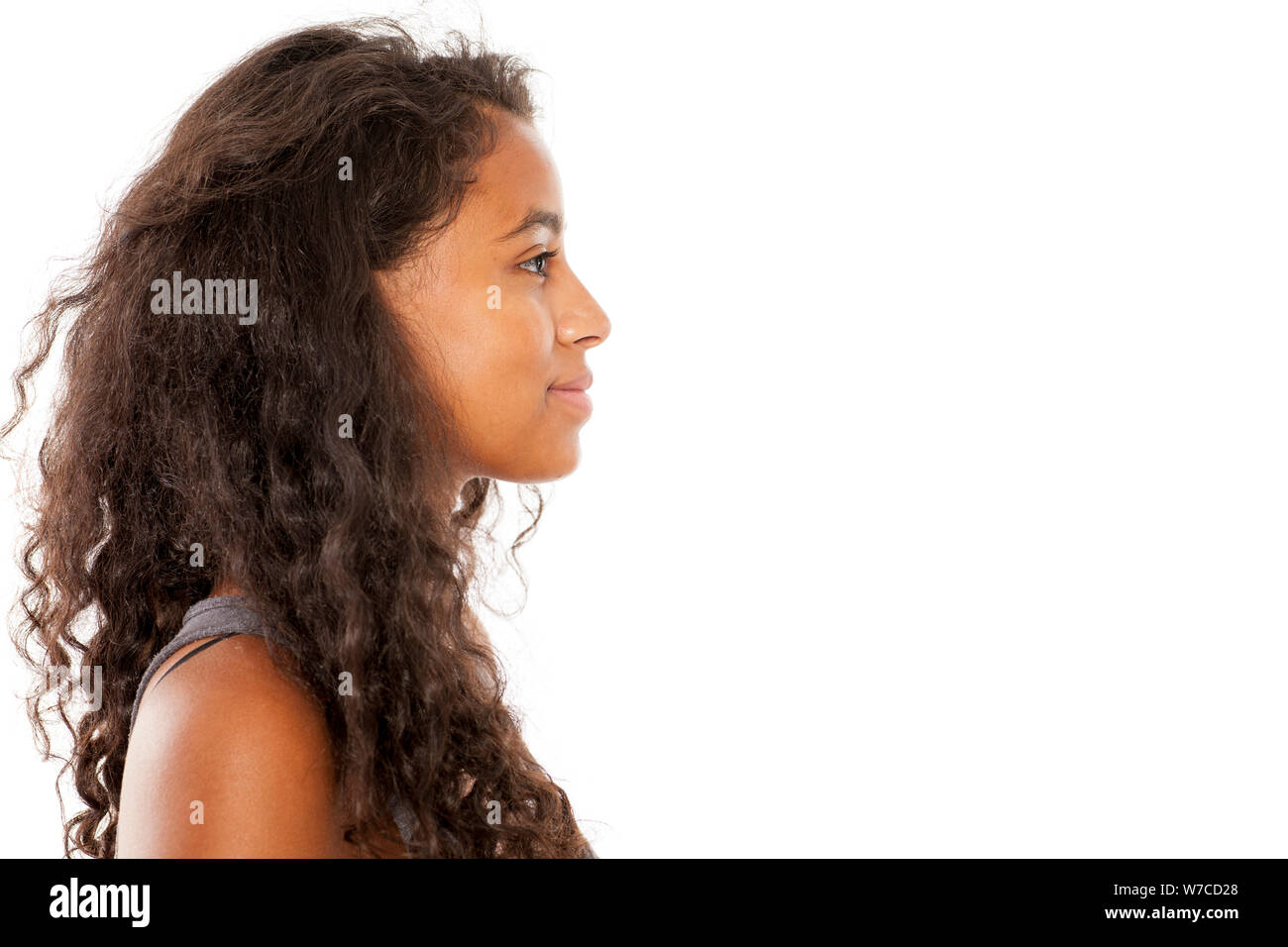profile of a smiling, beautiful young dark-skinned woman Stock Photo