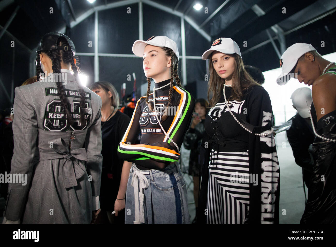 Russian model Vlada Dzyuba, second left, prepares to display a new creation at the fashion show of HUI BY ERAN HUI during the Shanghai Fashion Week Sp Stock Photo