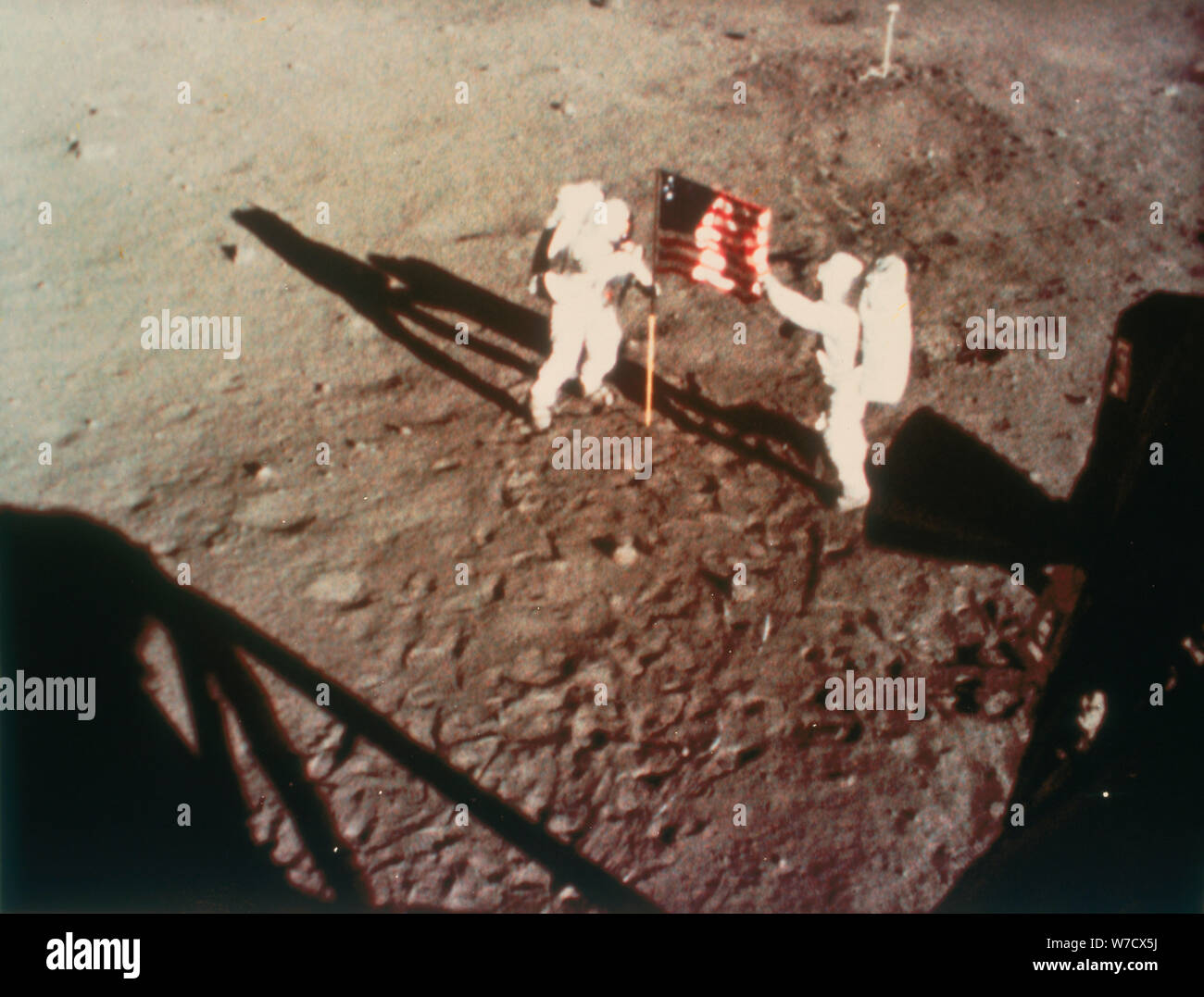 Armstrong and Aldrin unfurl the US flag on the moon, 1969. Artist: Unknown Stock Photo