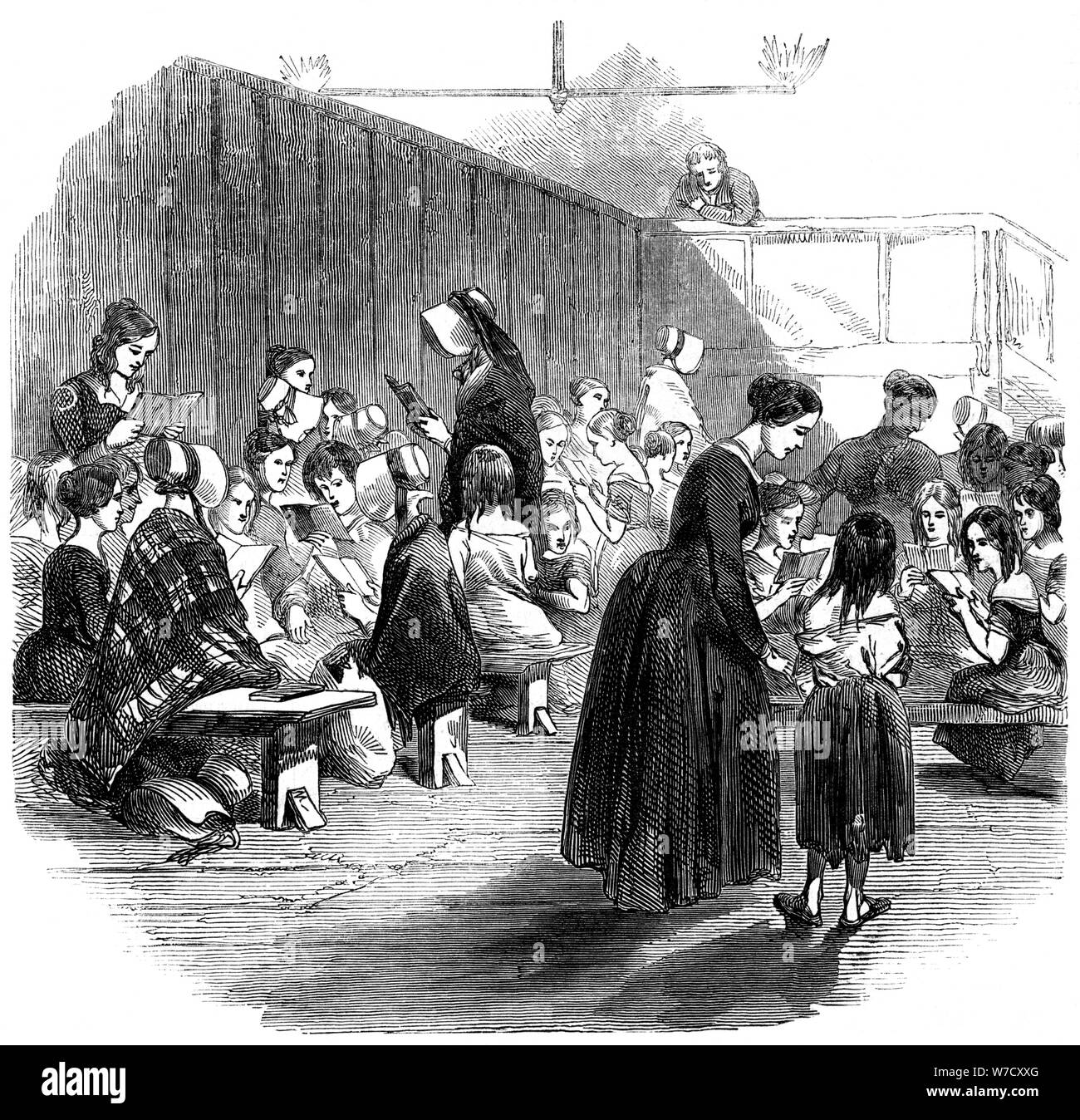 Teaching girls to read in the Ragged School Union school, Lambeth, London, 1868. Artist: Unknown Stock Photo