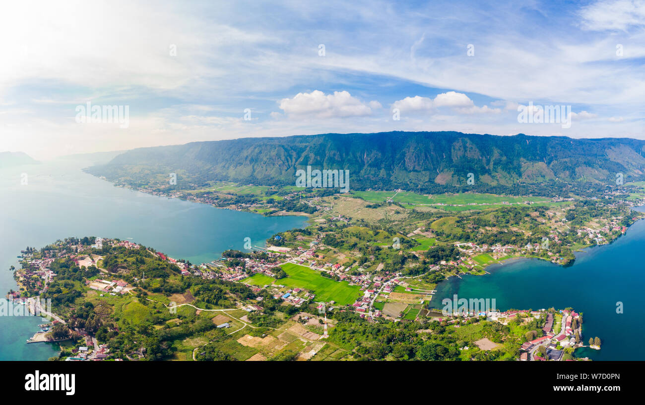 Aerial: lake Toba and Samosir Island view from above Sumatra Indonesia. Huge volcanic caldera covered by water, traditional Batak villages, green rice Stock Photo