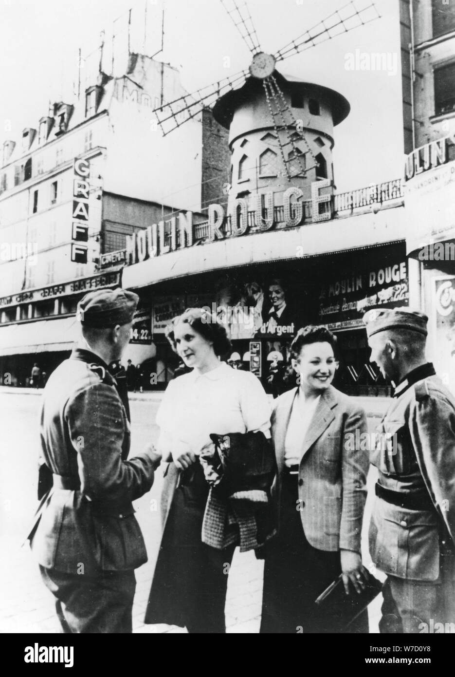 German soldiers chatting up French women outside the Moulin Rouge, occupied Paris, June 1940. Artist: Unknown Stock Photo