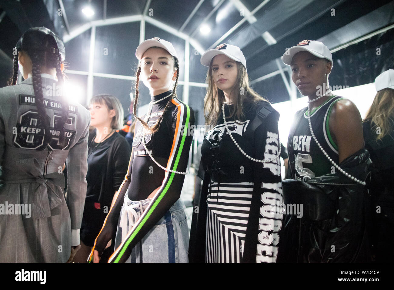 Russian model Vlada Dzyuba, second left, prepares to display a new creation at the fashion show of HUI BY ERAN HUI during the Shanghai Fashion Week Sp Stock Photo