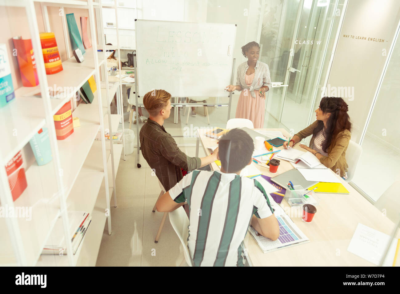Positive delighted young people studying in language school Stock Photo