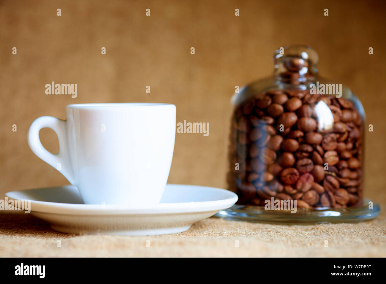White cup with coffee on a blurred background. Stock Photo