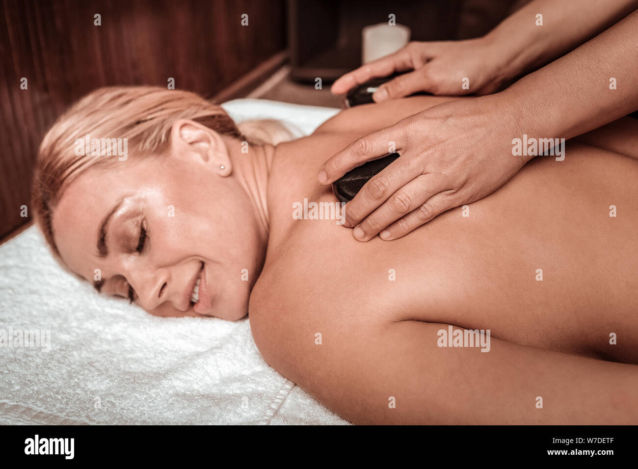 Beautiful woman enjoying her hot stone massage. Stock Photo