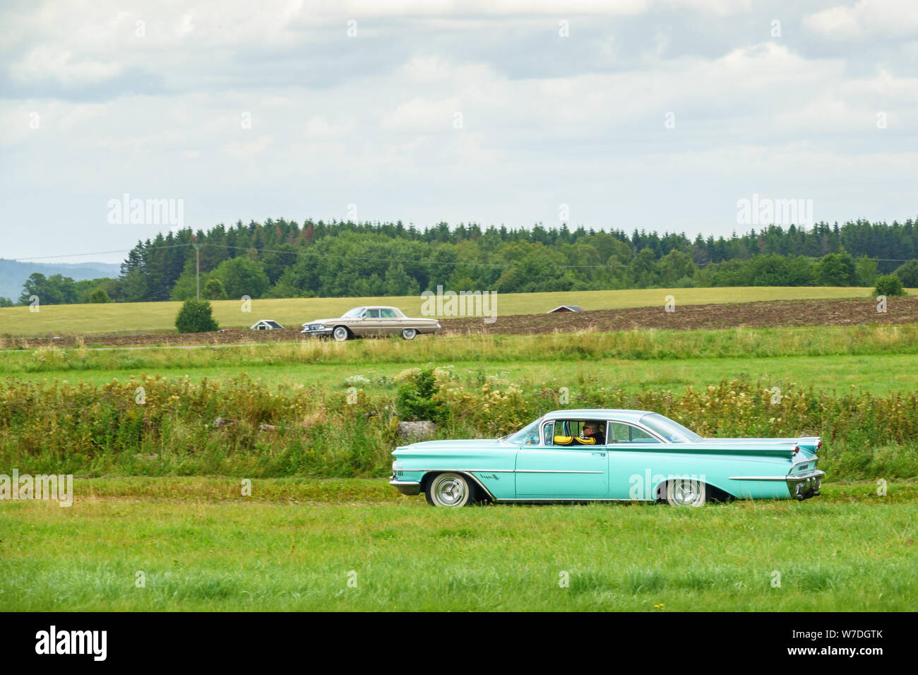 Classic cars driving in the countryside Stock Photo