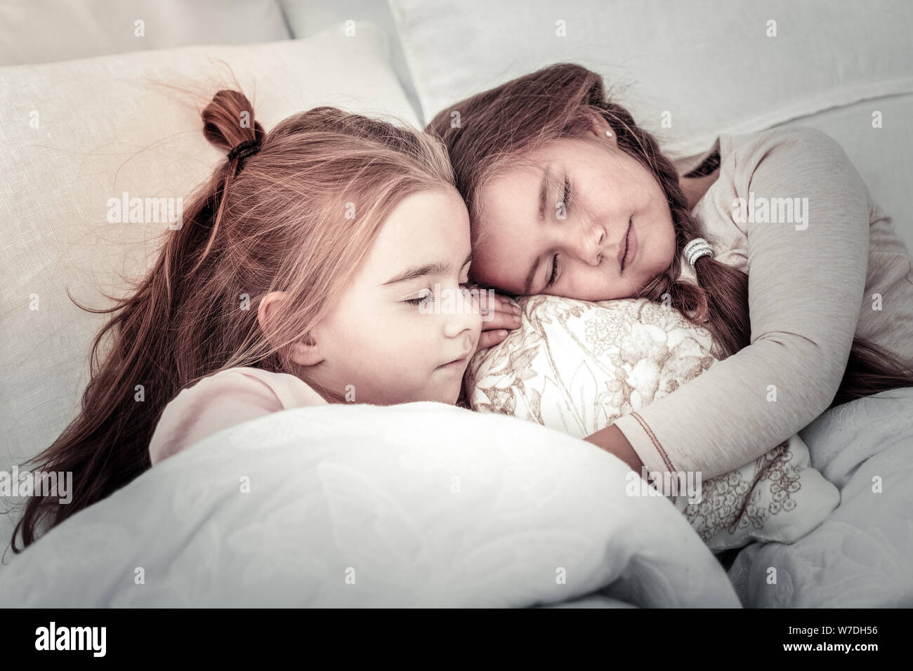 Two cute sleeping sisters in the morning Stock Photo Alamy