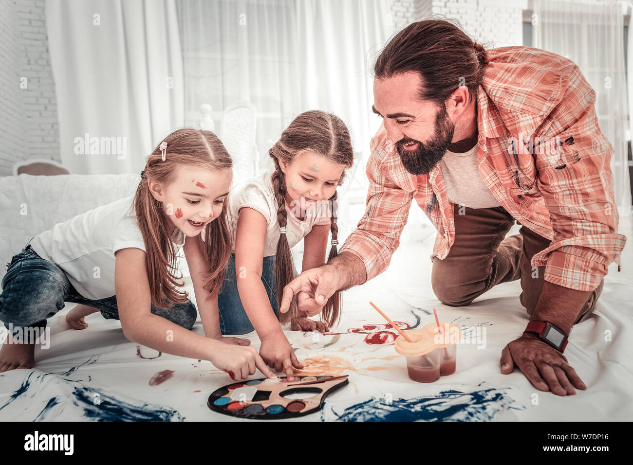 Good young father spending time together with his children painting Stock Photo