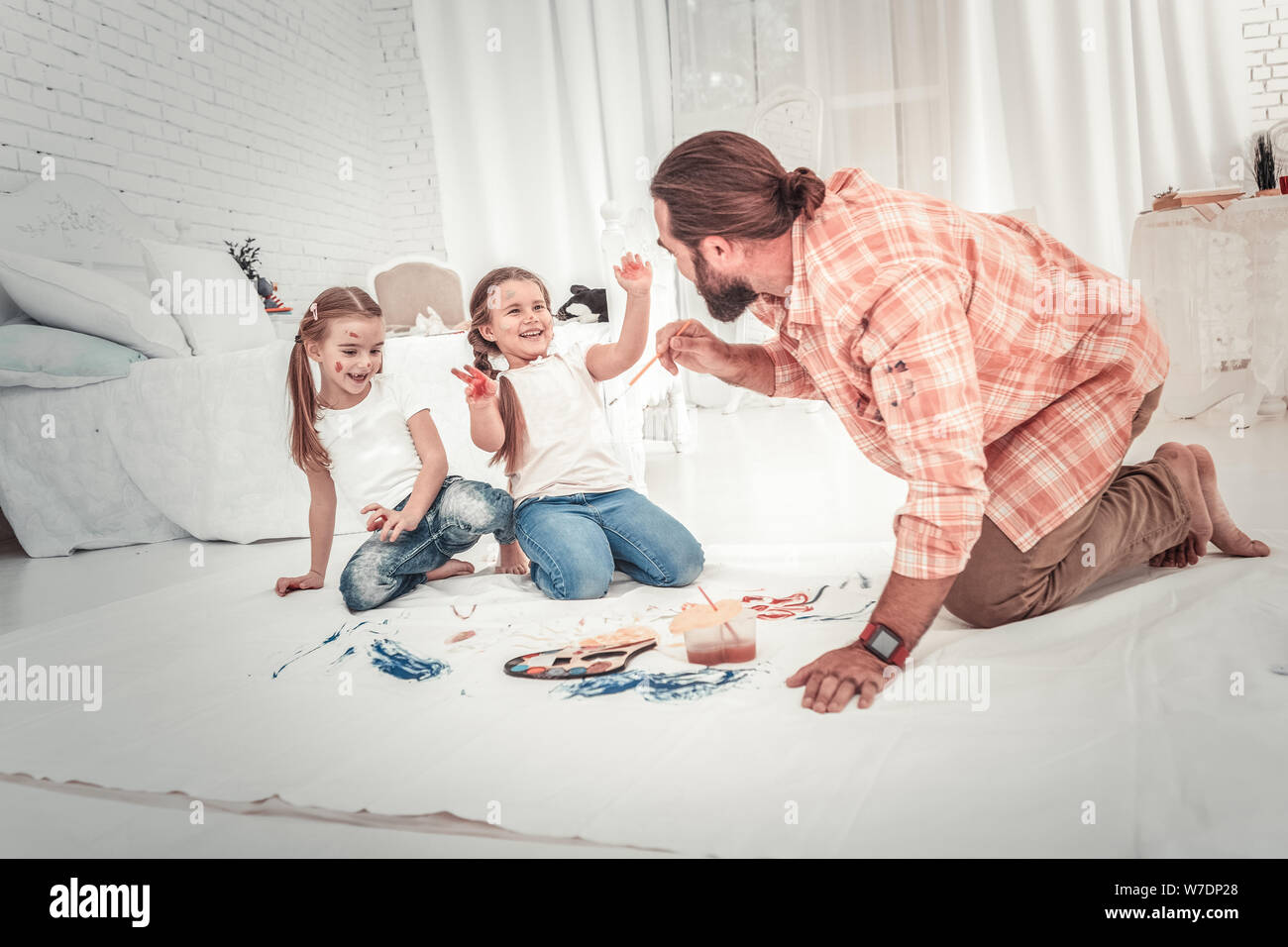 Smiling and happy kids drawing with their dad Stock Photo