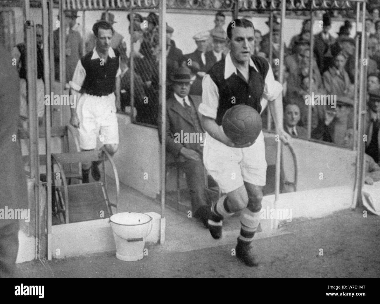 Arsenal FC captain Eddie Hapgood runs onto the pitch at Highbury, London, 1930s. Artist: Barratt's Photo Press Ltd Stock Photo