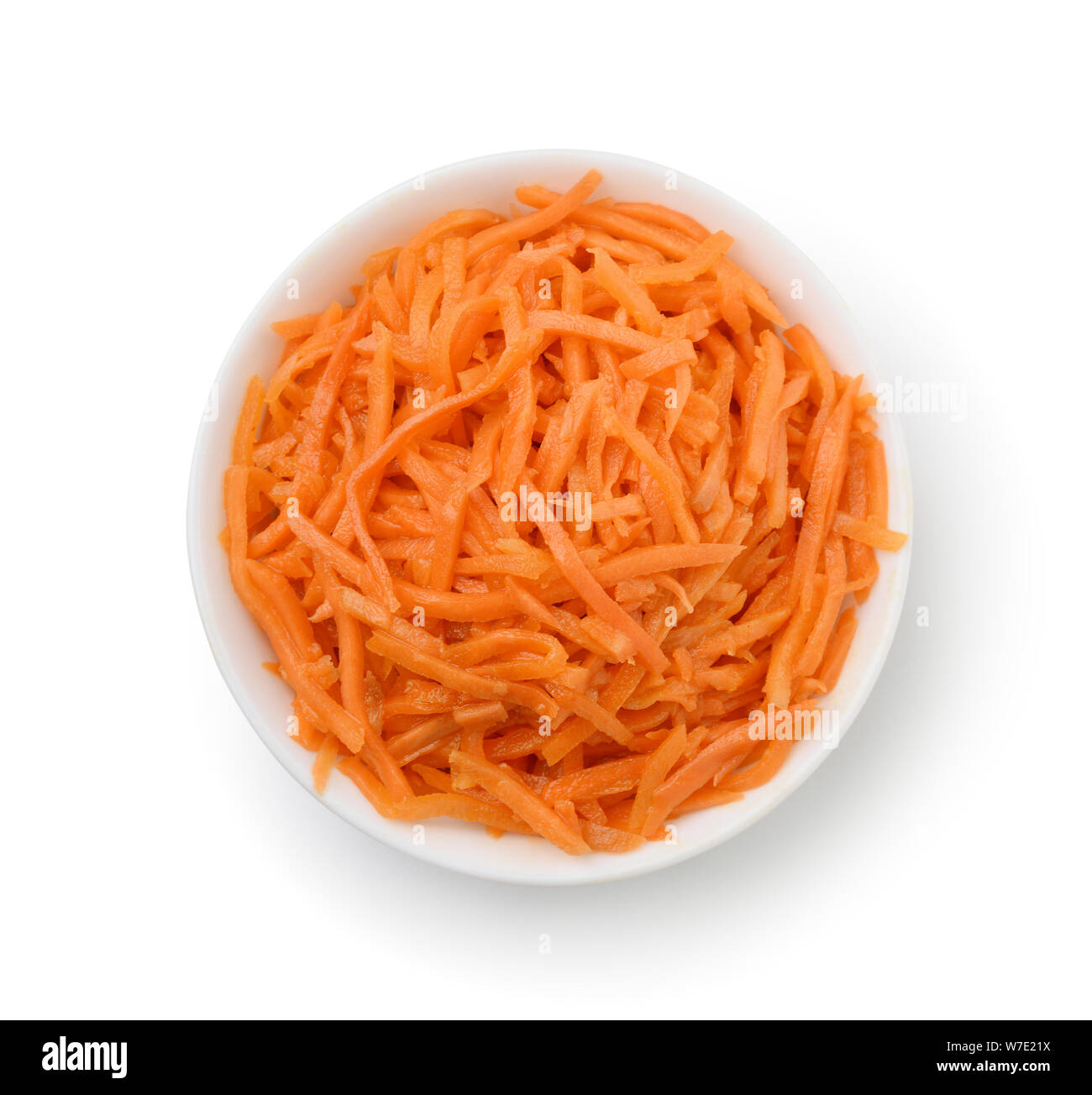Top view of grated carrot in bowl isolated on white Stock Photo