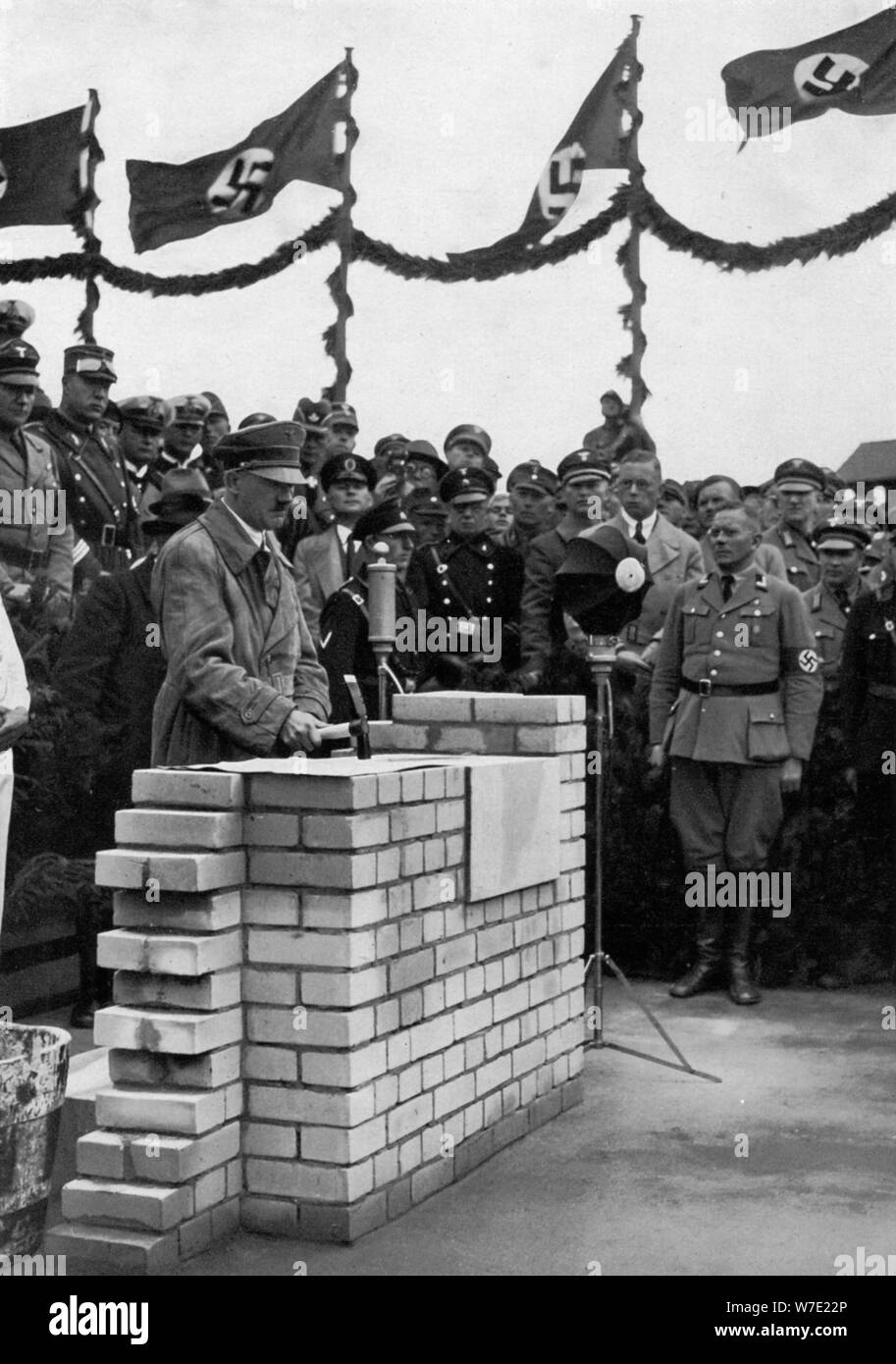 The Führer puts the foundation wall to the meeting house in the Adolf-Hitler-Koog. Artist: Unknown Stock Photo