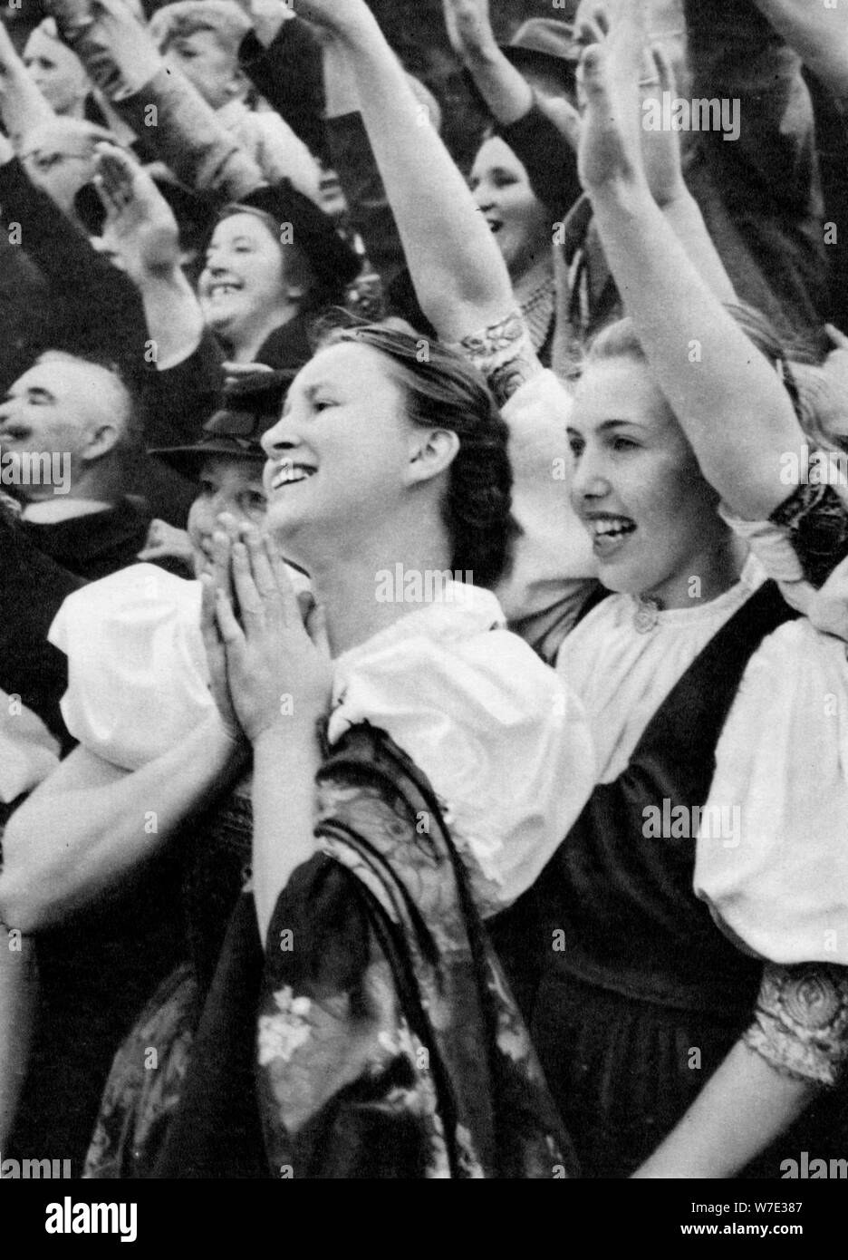 Admiring crowd saluting German Nazi leader Adolf Hitler, 1938. Artist: Unknown Stock Photo