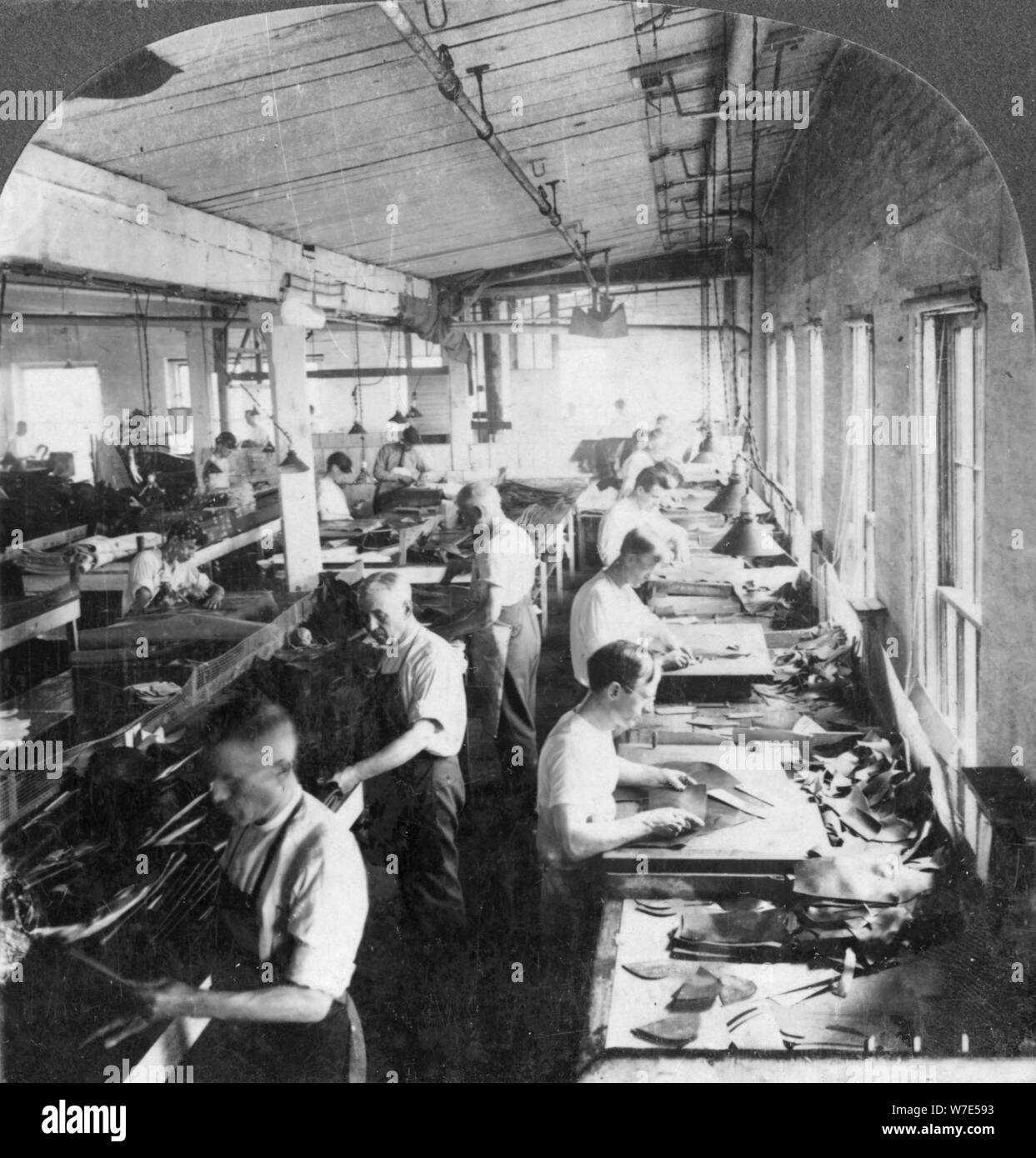 Workers cutting leather for shoes in a factory, Lynn, Massachusetts, USA, 20th century. Artist: Keystone View Company Stock Photo