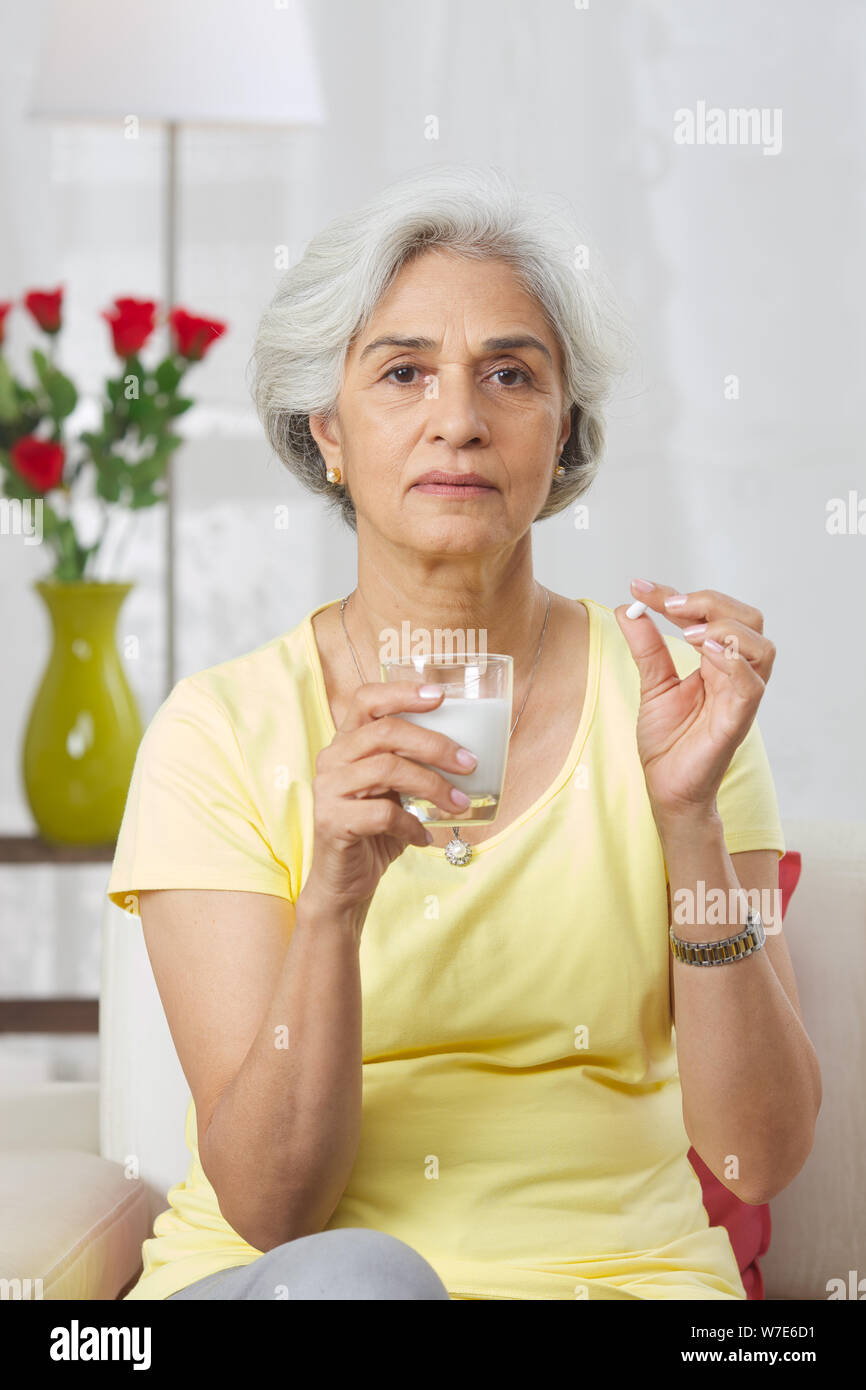 Old woman taking medicine Stock Photo Alamy