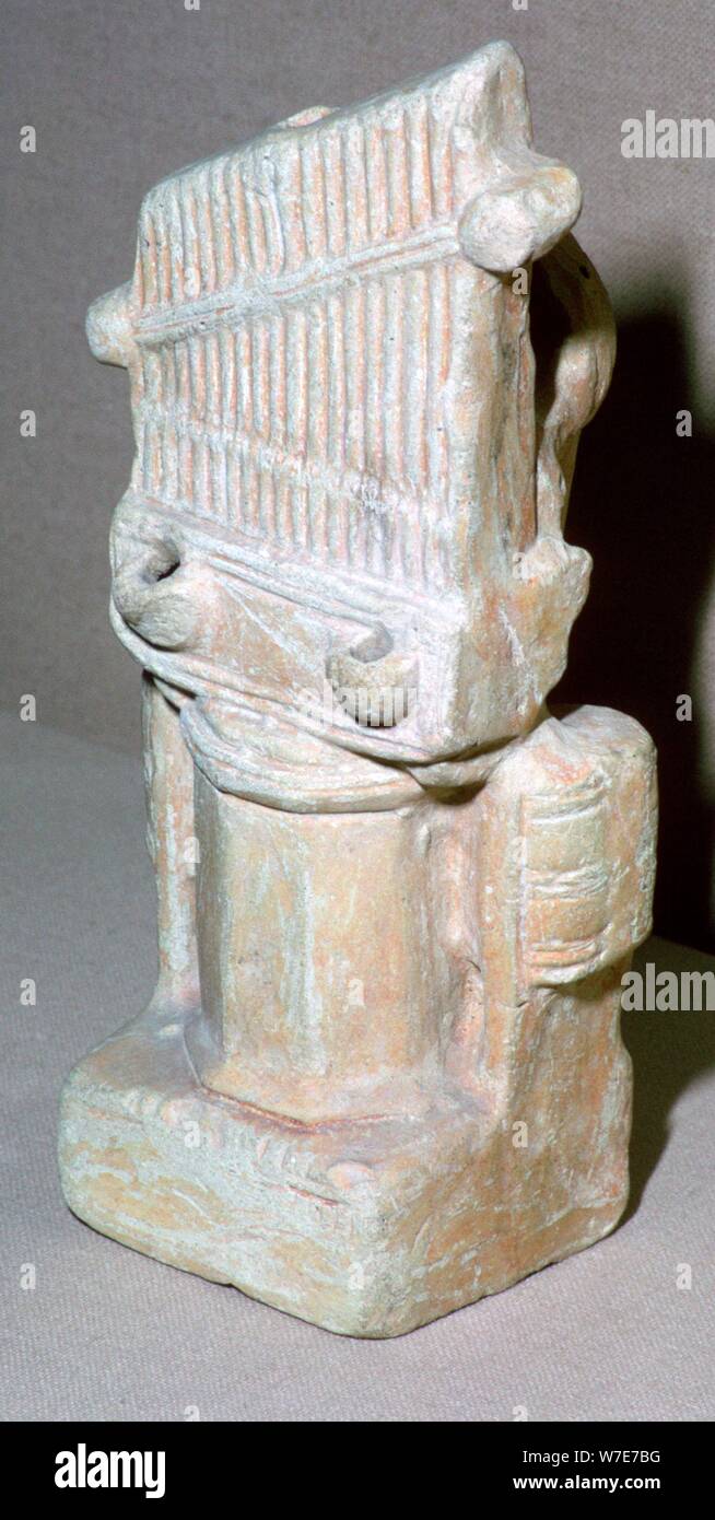 Roman terracotta lamp in the shape of a water-organ. Artist: Unknown Stock Photo