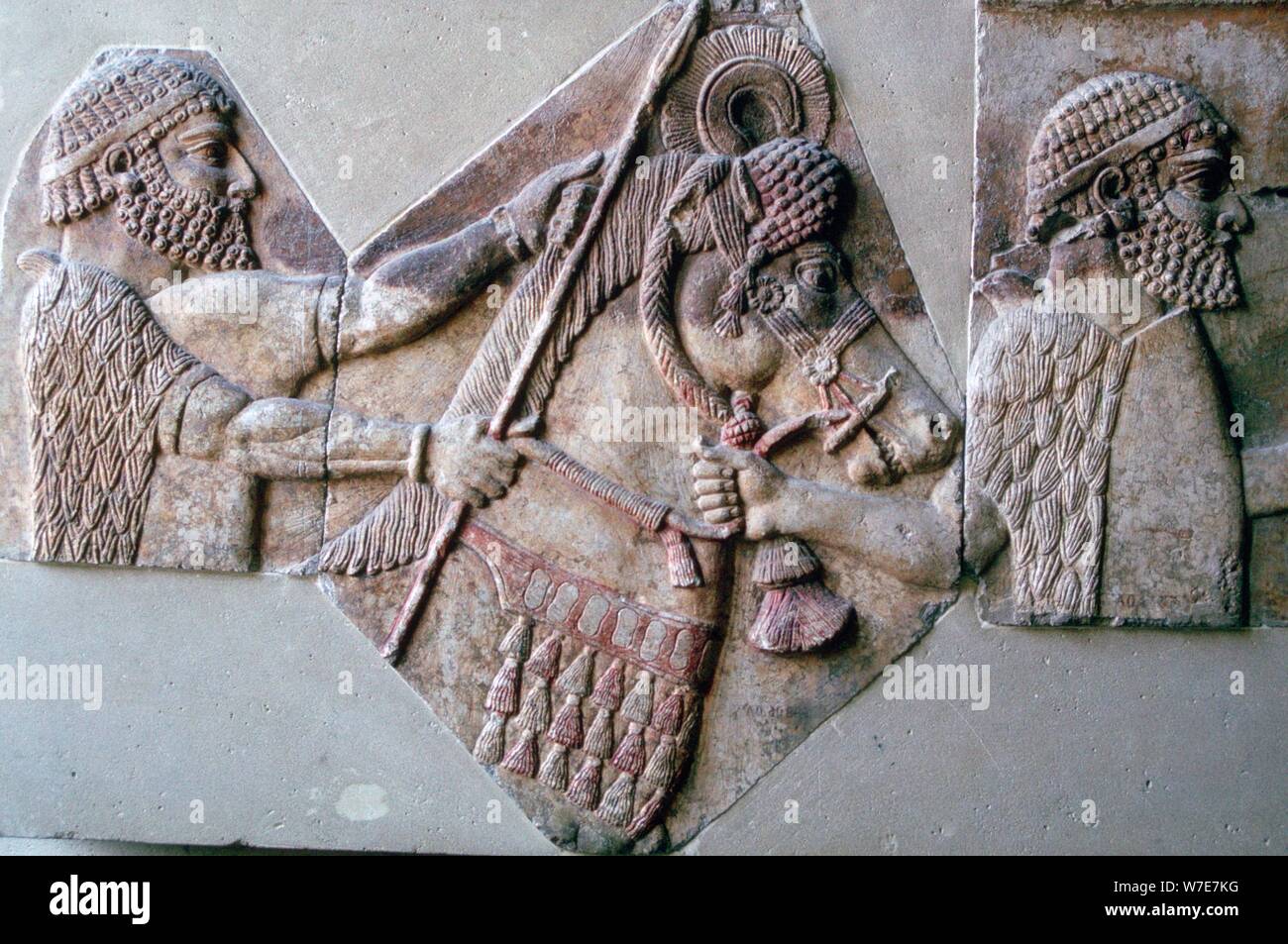 Assyrian relief of a man leading a horse and rider. Artist: Unknown Stock Photo