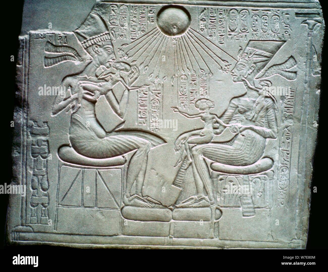 Egyptian relief of Akhenaten and Nefertiti holding their daughters, 14th century BC. Artist: Unknown Stock Photo