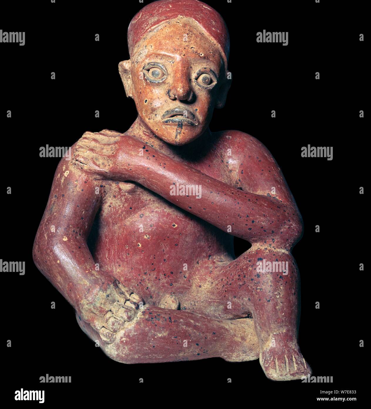 Mexican pottery figure of a squatting man, 4th century. Artist: Unknown Stock Photo