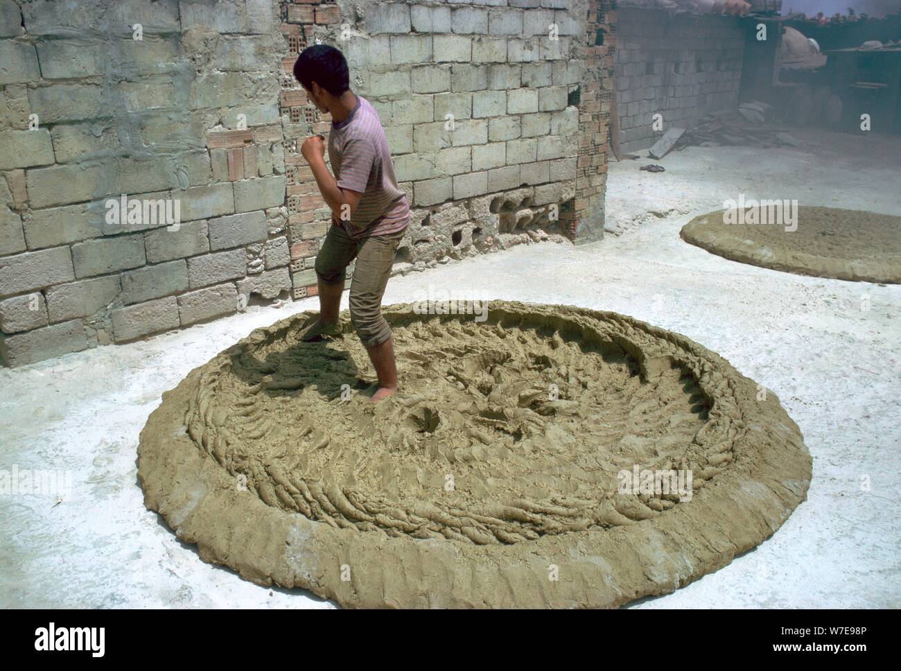 Treading clay for pottery in Tunisia. Artist CM Dixon Artist Unknown