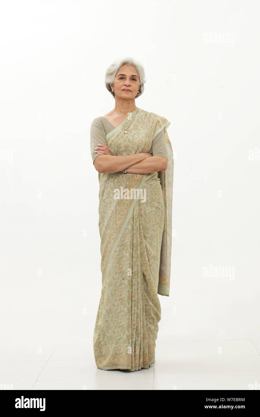 Old woman standing with her arms crossed Stock Photo