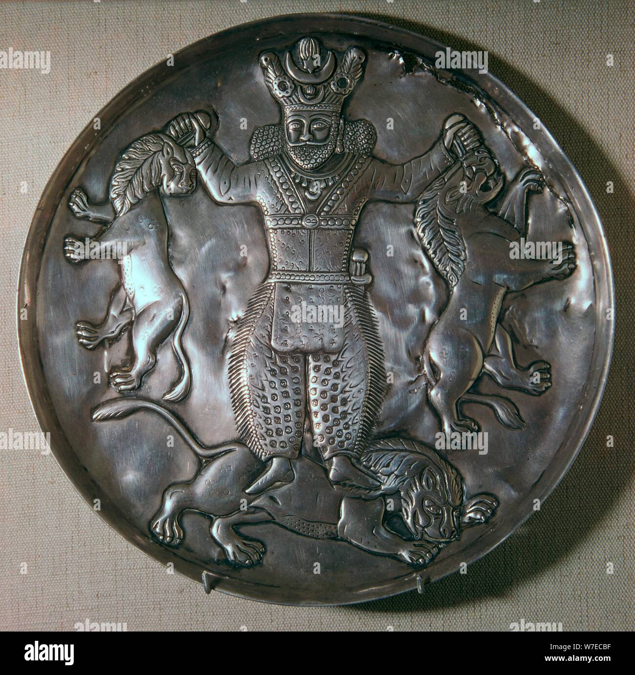 Sassanian dish showing a king holding lions. Artist: Unknown Stock Photo