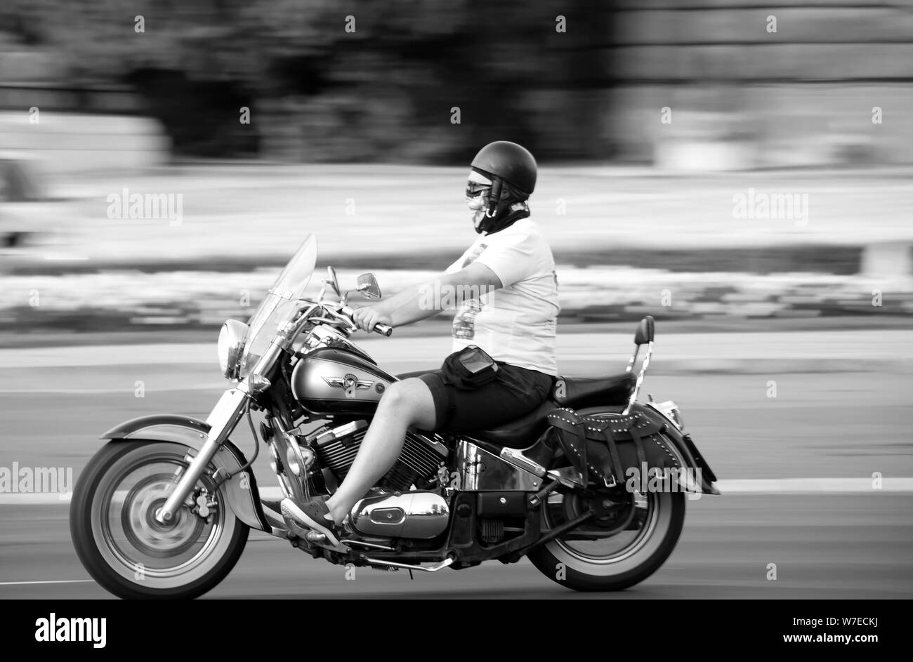 Belgrade, Serbia - July 30, 2019: One man riding a chopper motorbike on a summer day, in black and white Stock Photo