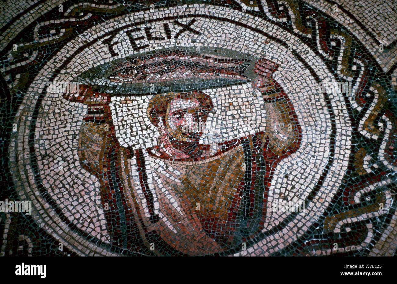 Roman mosaic of a man carrying fish. Artist: Unknown Stock Photo