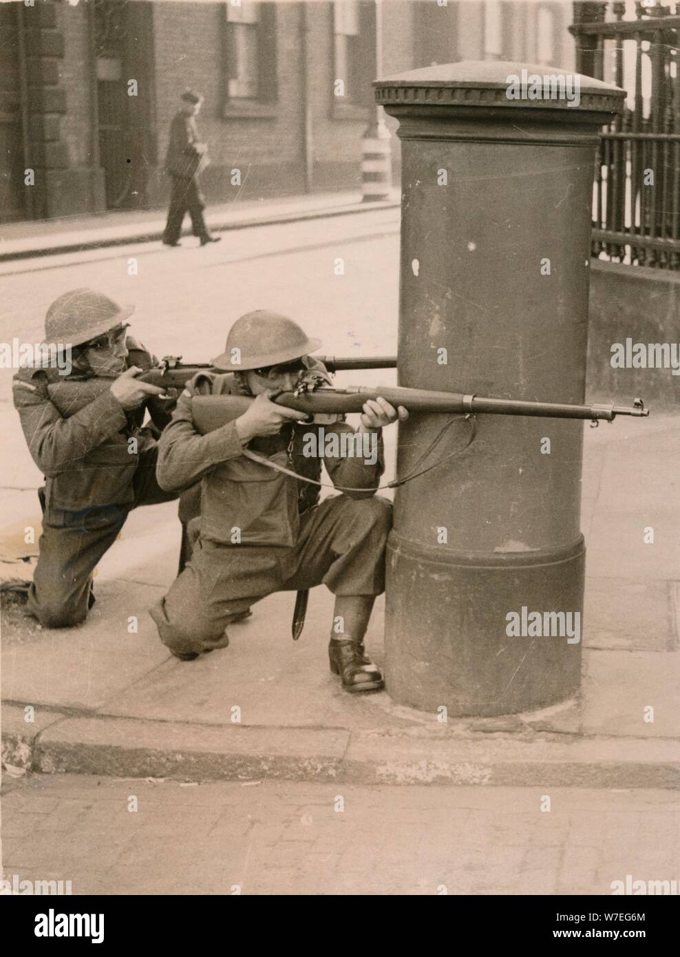 The Home Guard find cover behind a pillar box during a enemy engagement rehearsal, 1941. Artist: Unknown Stock Photo