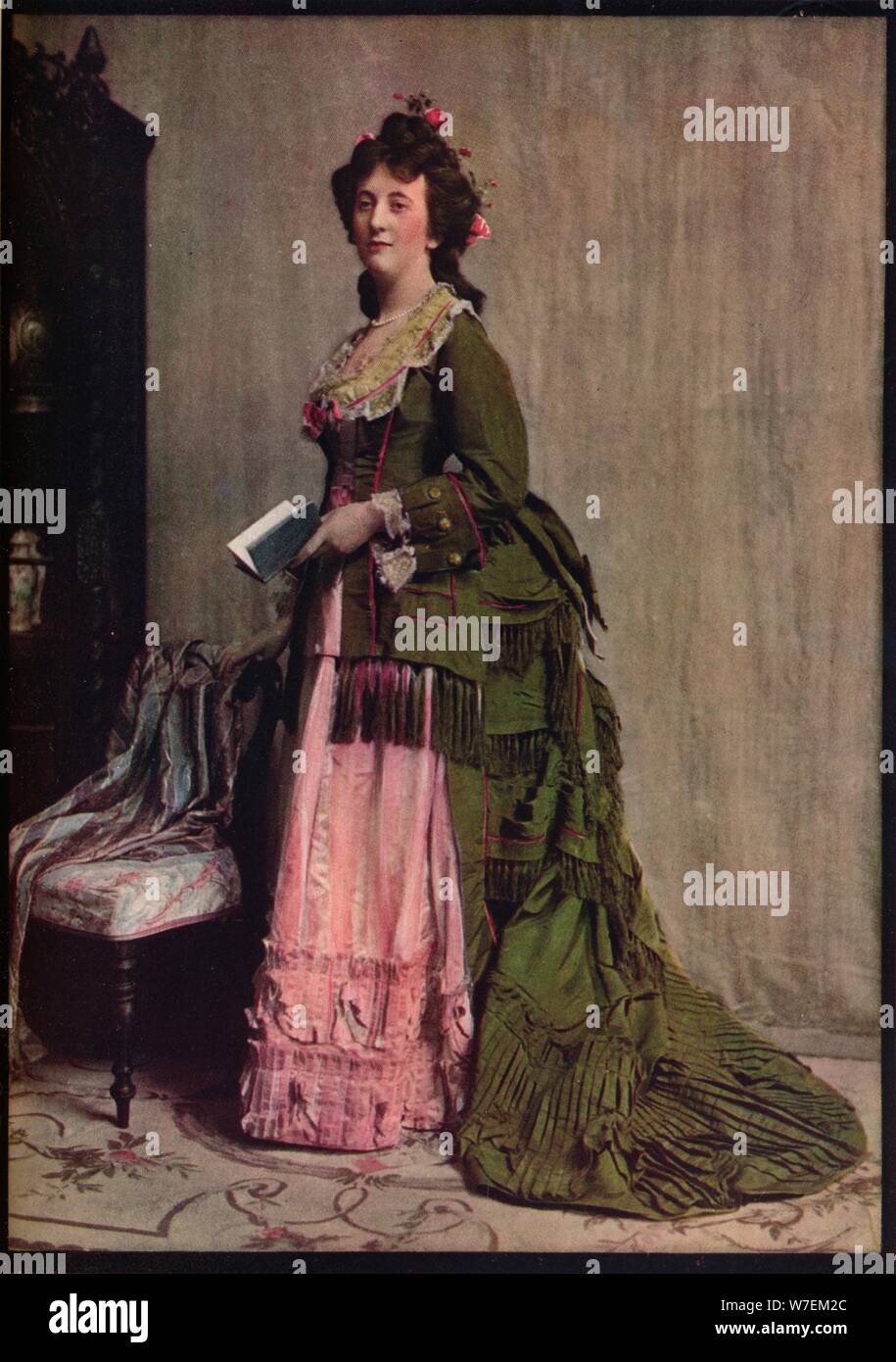 'An afternoon dress of green and pink silk. Very typical of the modes between 1868 and 1878', c1913. Artist: Unknown. Stock Photo