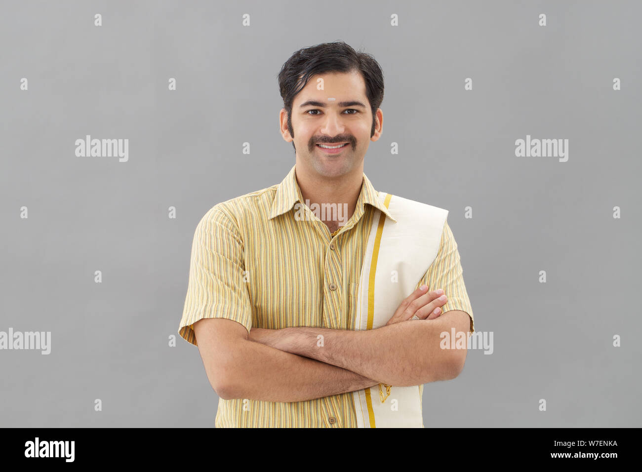 South Indian man standing with his arms crossed Stock Photo - Alamy