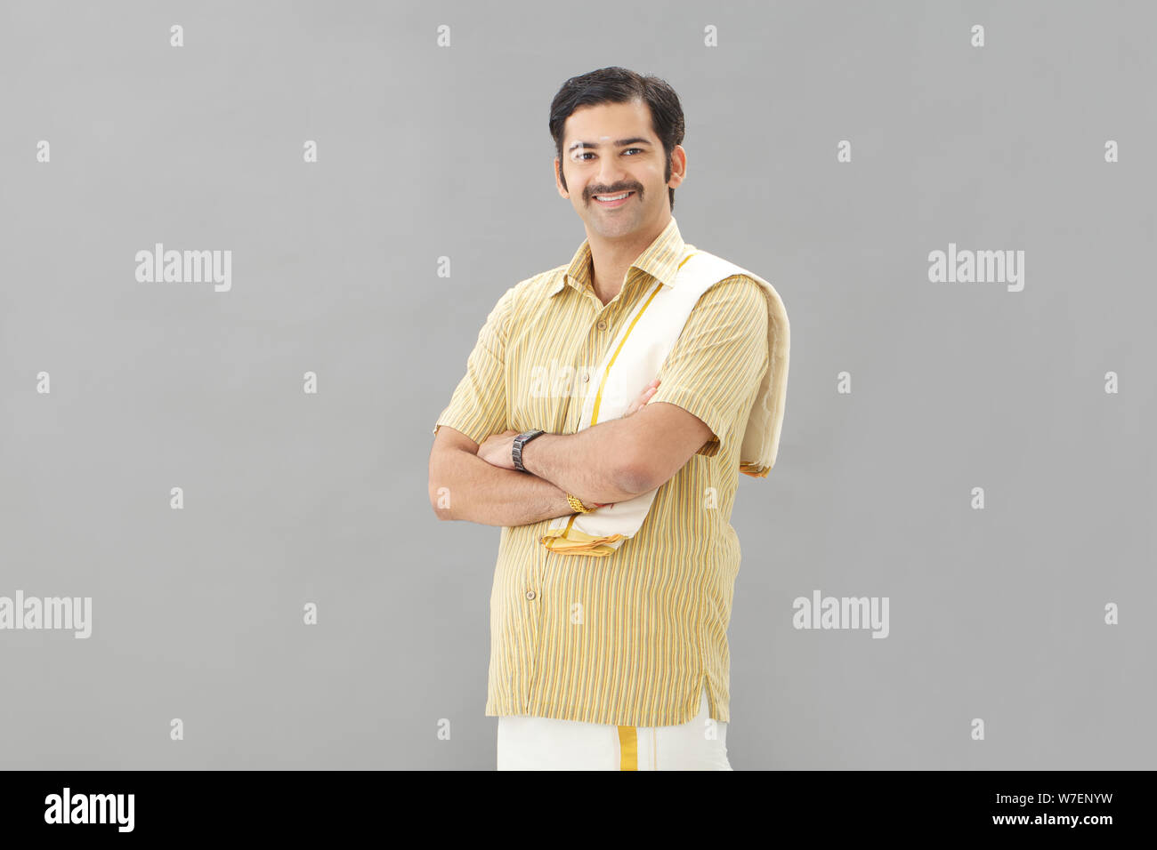 South Indian man standing with his arms crossed Stock Photo - Alamy