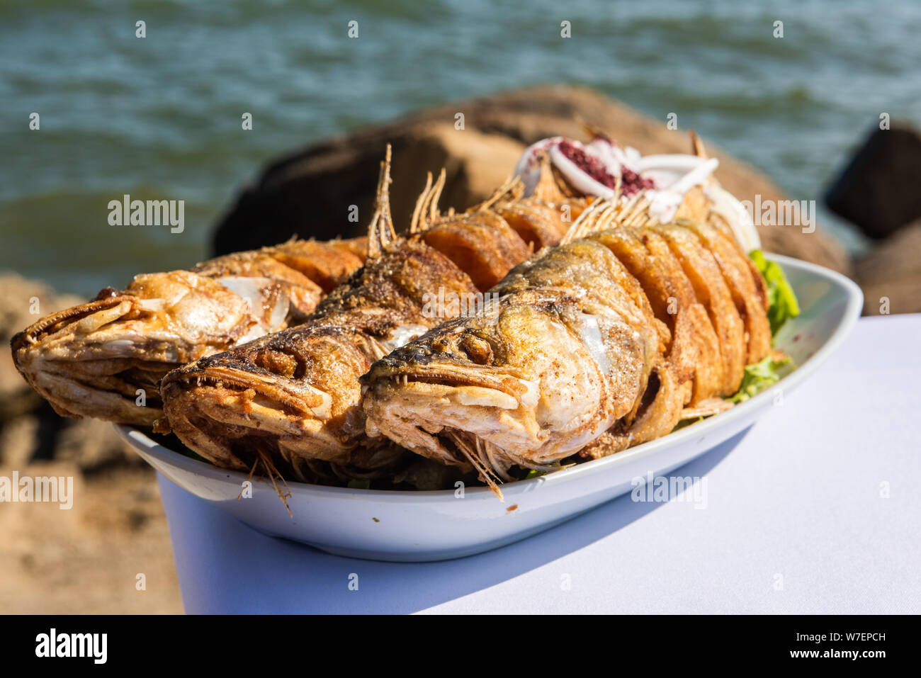 Plate with three pike-perch fish served in a fishing restaurant in Bibi-Heybat settlement of Baku, Azerbaijan. Stock Photo