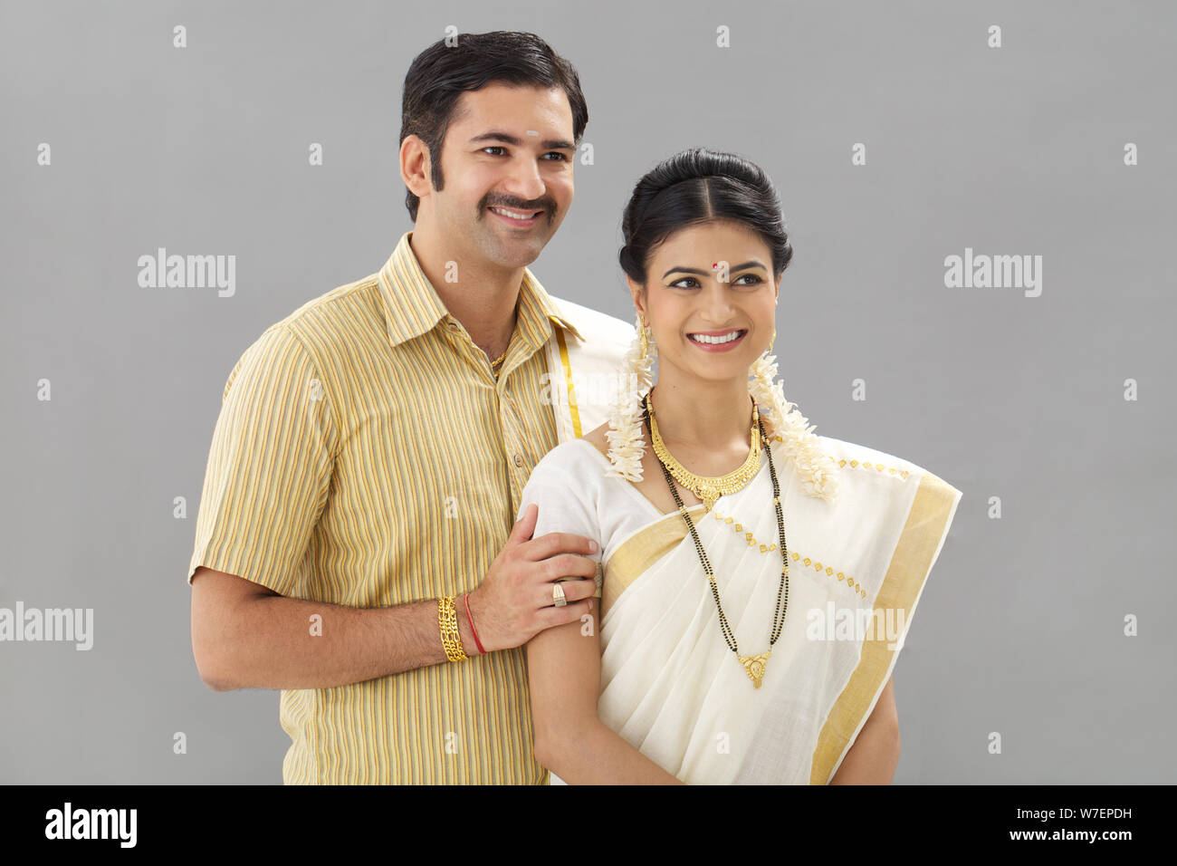 South Indian couple standing together smiling Stock Photo - Alamy