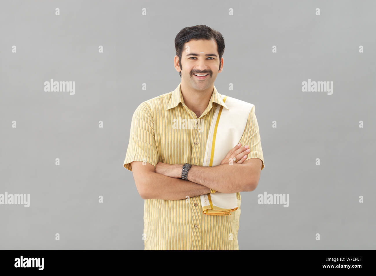 South Indian man standing with his arms crossed Stock Photo - Alamy