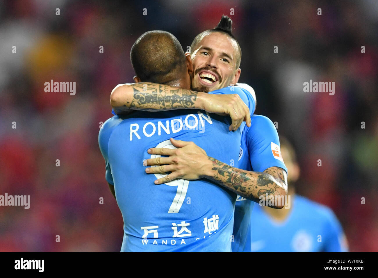 Venezuelan football player Salomon Rondon, left, of Dalian Yifang  celebrates with Slovak football player Marek Hamsik after scoring against  Chongqing SWM in their 21st round match during the 2019 Chinese Football  Association