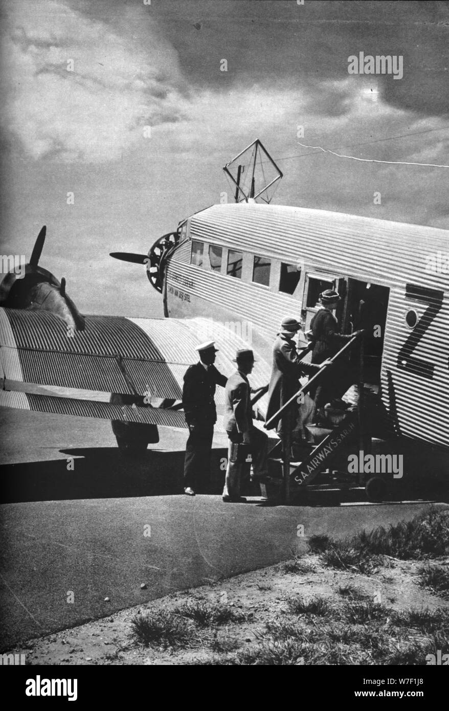 Passengers boarding one of the Junkers airliners of South African Airways, c1936 (c1937). Artist: Unknown. Stock Photo
