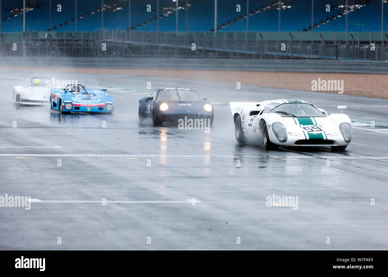 Competitors were backed-up,  behind the safety car, after an incident during  a rainy HSCC Thundersports race, at the 2019 Silverstone Classic Stock Photo