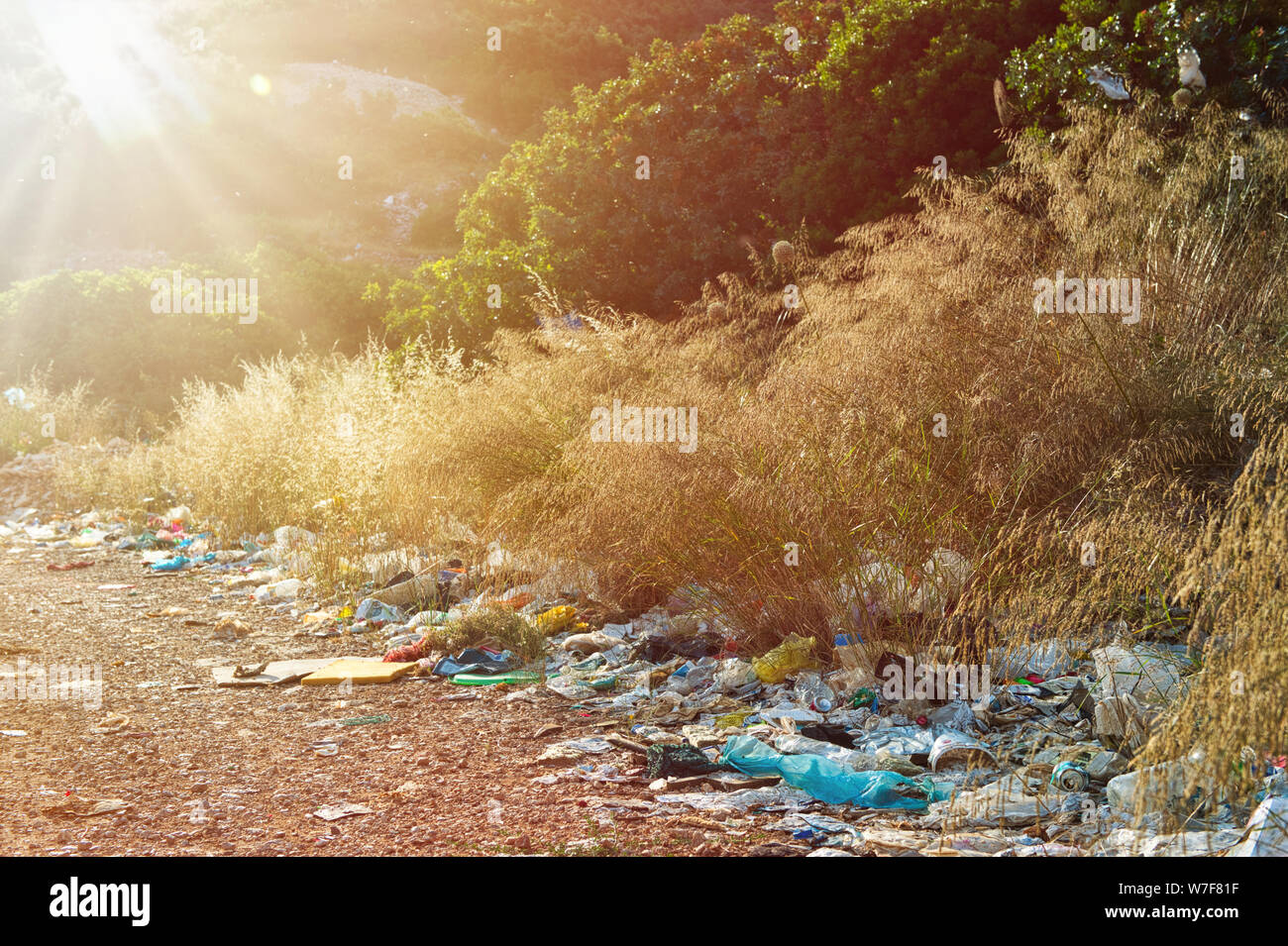 Illegal dumping of rubbish in natural enviroment. Fly tipping, bad waste mamagement, illegal landfill, enviromental issues. Stock Photo