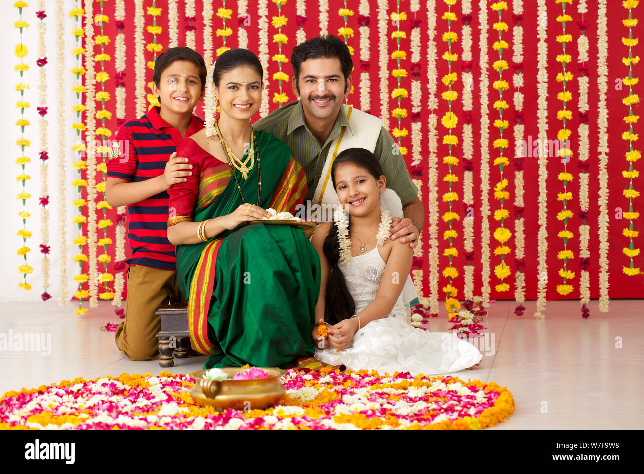 Portrait of a South Indian family making rangoli Stock Photo - Alamy