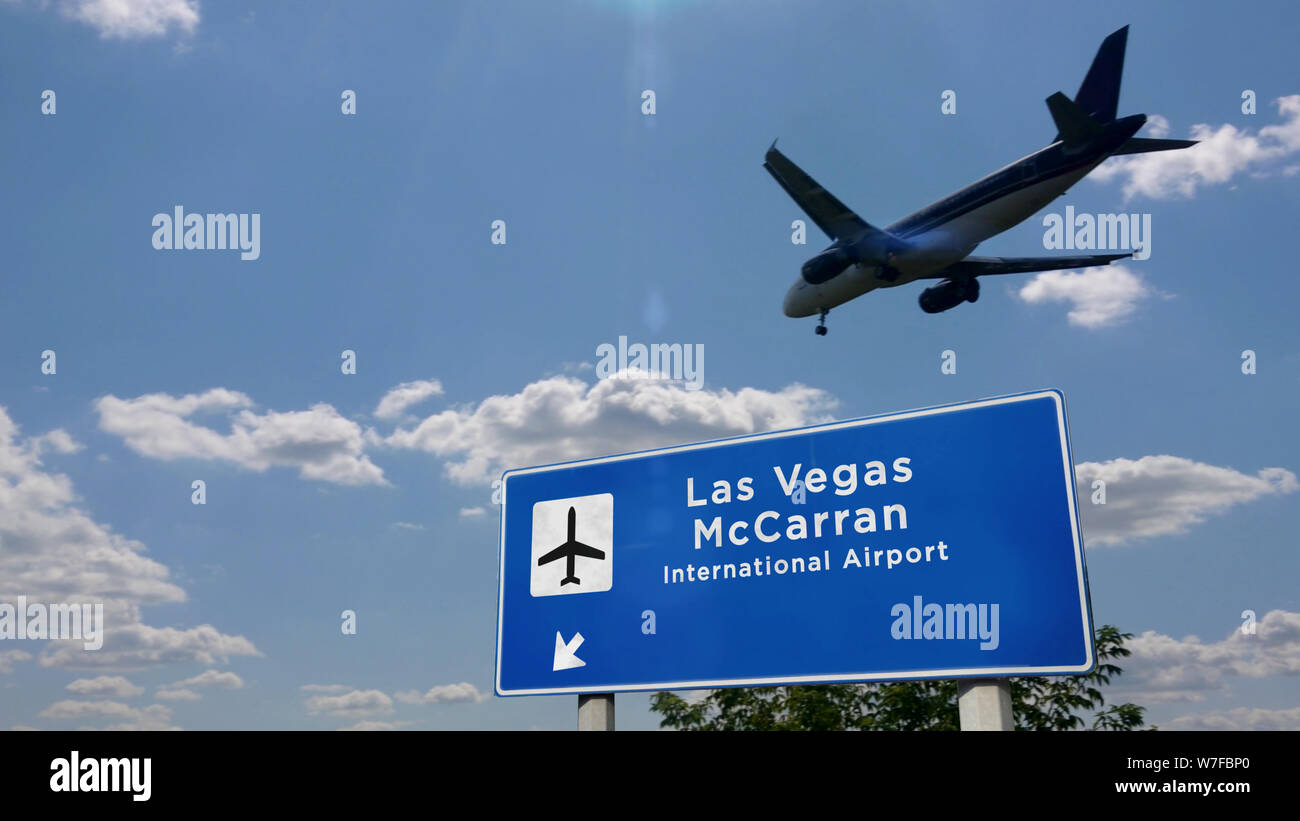 Airplane silhouette landing in Las Vegas, McCarran, Nevada, United States. City arrival with airport direction signboard and sunset in background. Tri Stock Photo