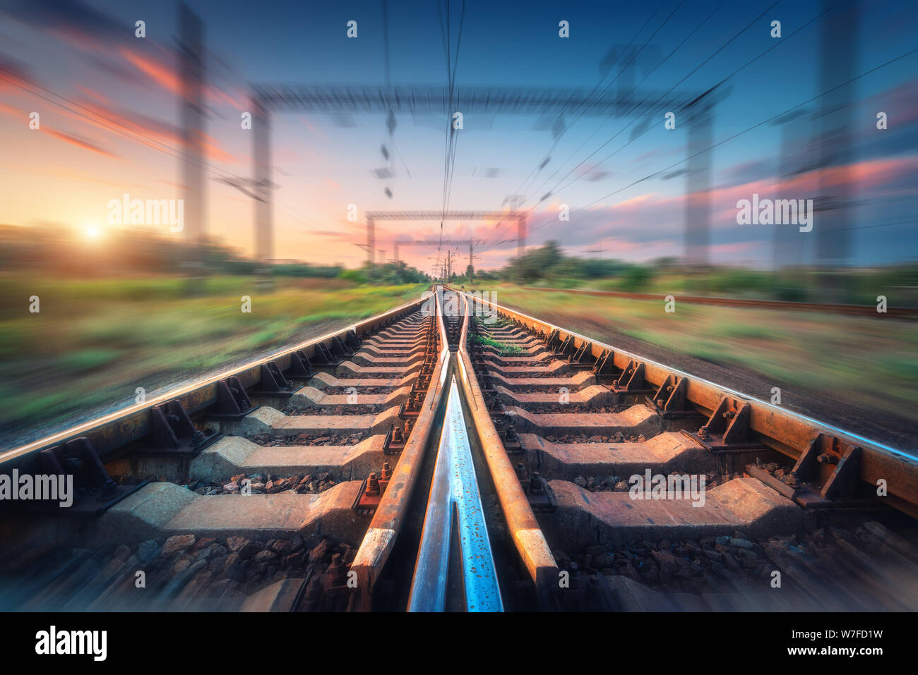 Railroad and beautiful sky at sunset with motion blur effect Stock Photo