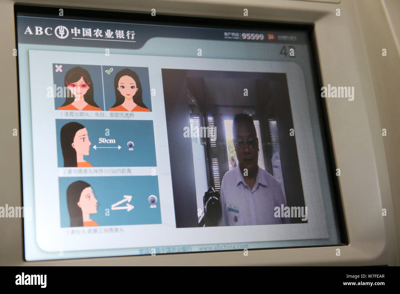 A client scans his face as he uses selfservice banking to deposit or