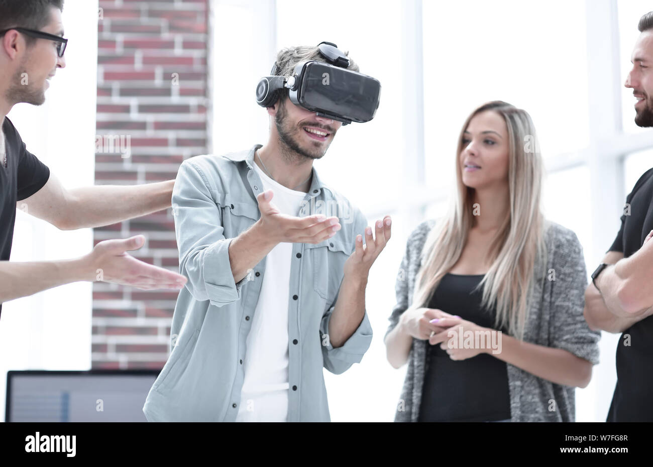Positive colleagues testing virtual reality glasses Stock Photo