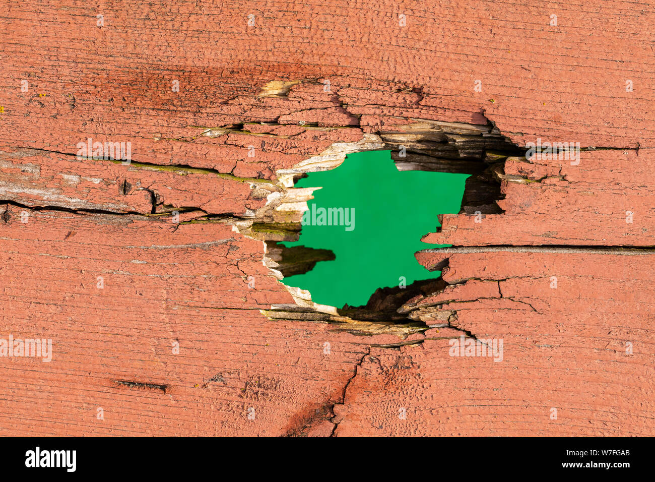 Hole In Board with Green Background Stock Photo