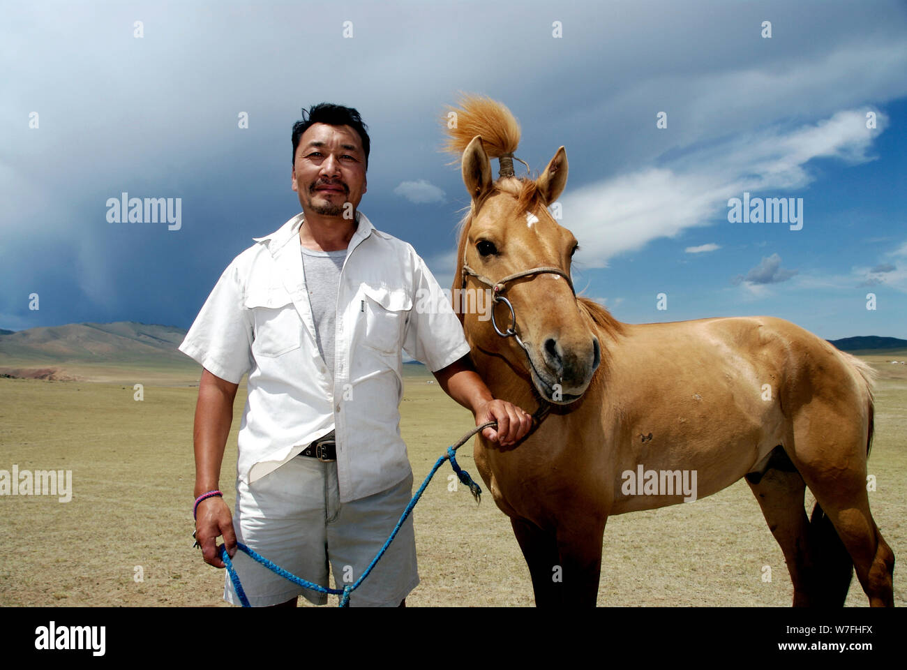 A Mongolian nomad proudly poses with its horse during the Nadaam ...