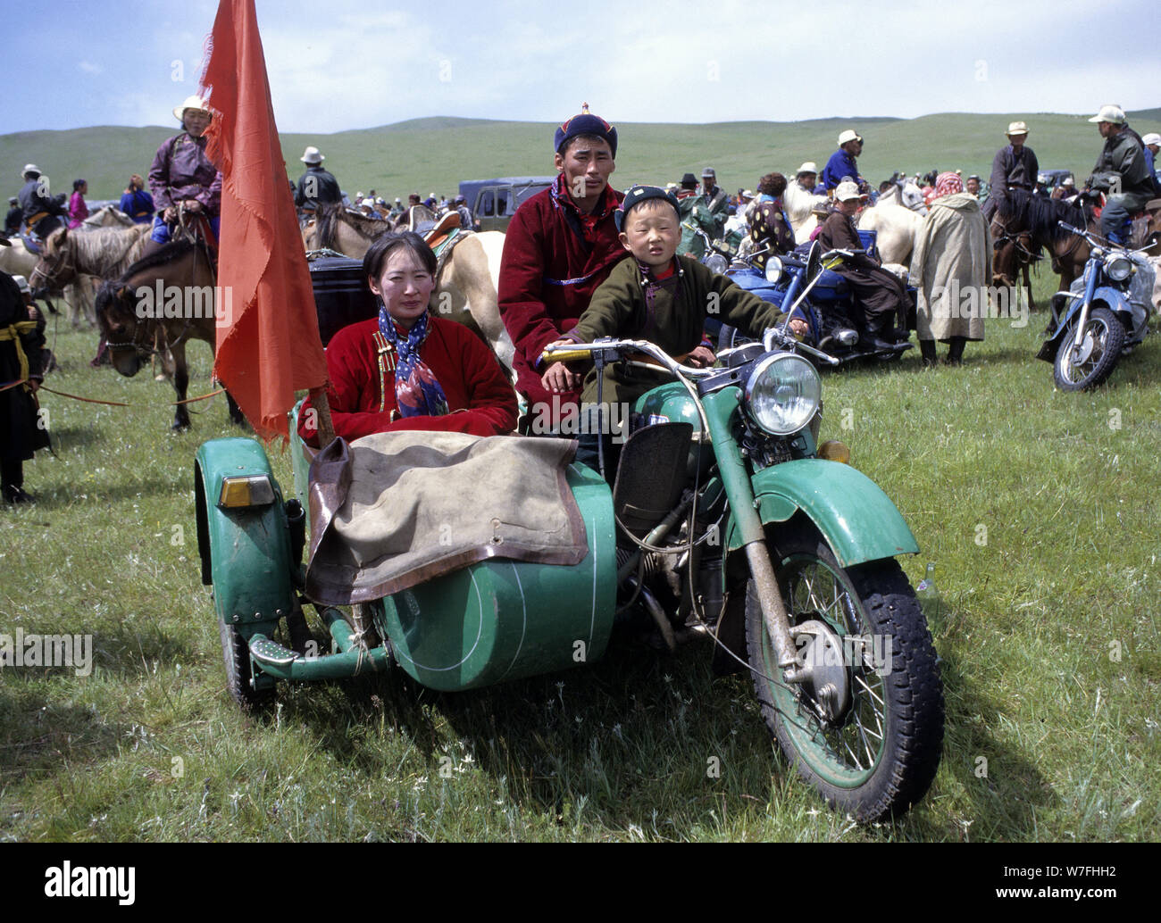 A Mongolian family proudly poses in its Ural side car during the Nadaam festival Stock Photo