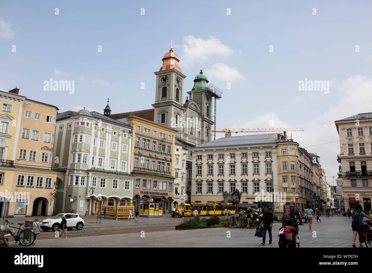 The Hauptplatz (main square) with its shops and restaurants and the old cathedral (St Ignatius) in Linz, Austria. Stock Photo