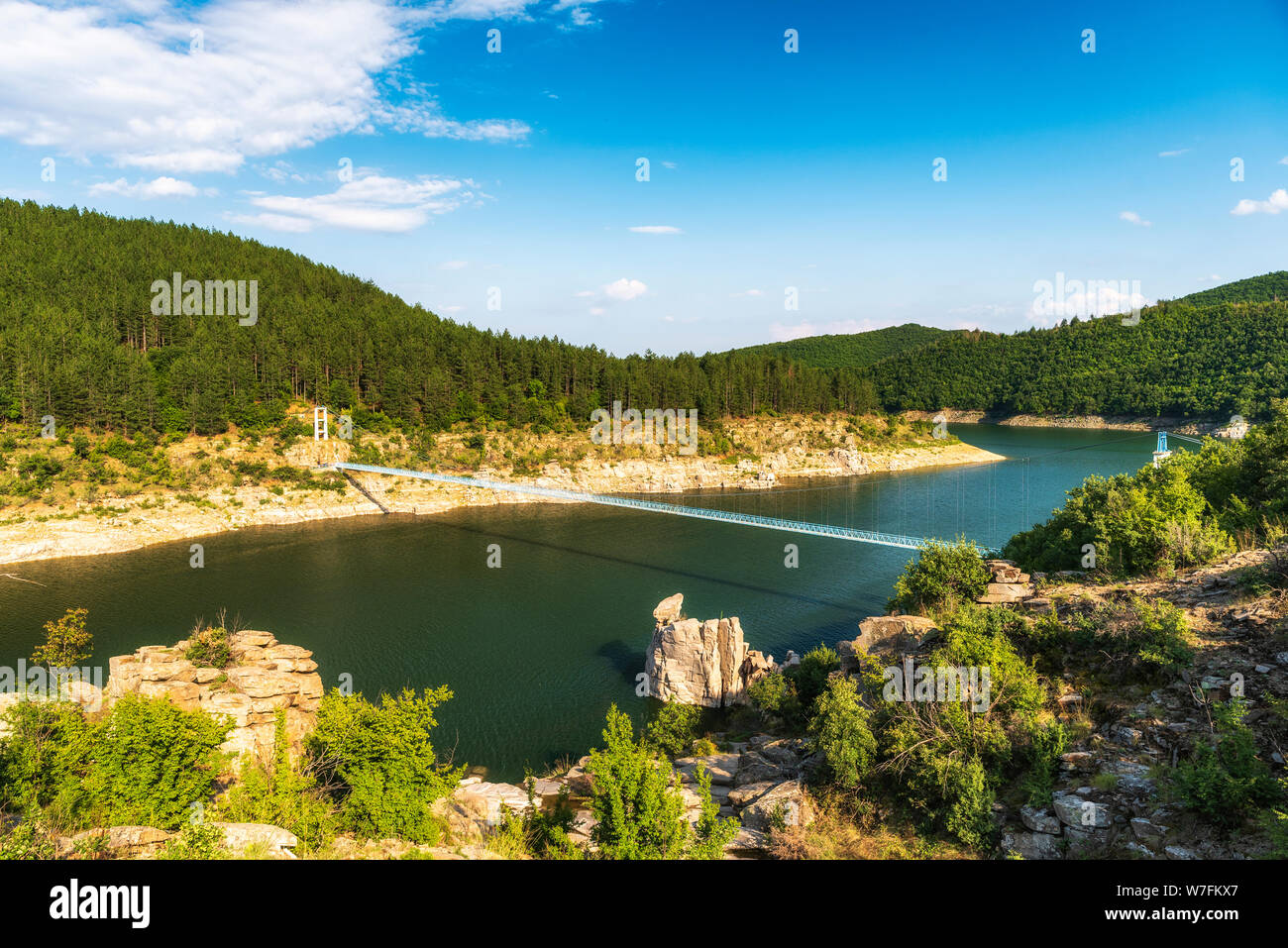 Suspension bridge over river Stock Photo